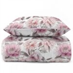 White bed dressed in pink and gray floral bedding with matching pillow shams.