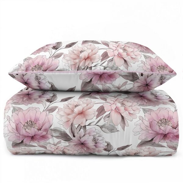 White bed dressed in pink and gray floral bedding with matching pillow shams.