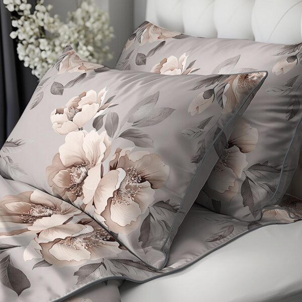 Floral-patterned throw pillows in soft gray and blush tones on a bed with a tufted headboard.