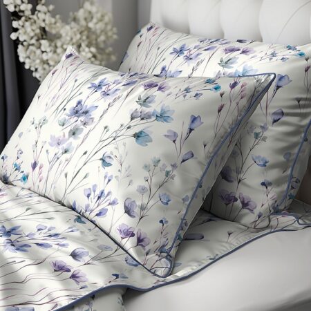 Twin beds with white floral-printed bedding and matching pillows featuring blue and lavender flowers on a white background.