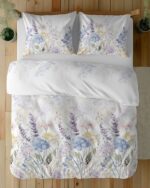 White bedding with pastel watercolor florals (purple, blue, yellow) on a bed viewed from above, with matching pillowcases.
