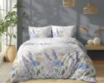 Queen bed with white floral duvet and pastel lavender, blue, and yellow pillows; grey wall and wooden floor.
