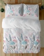 White bedding set with watercolor floral pattern in pink, blue, and lavender tones on duvet and pillows atop a wooden bed frame.