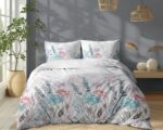 Bed with pastel floral duvet and matching pillows in a sunlit, modern bedroom.