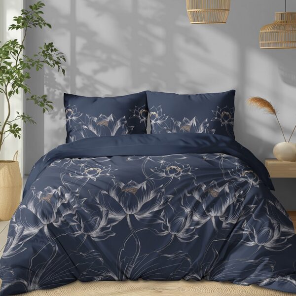 Bedroom with navy blue floral duvet and pillows, a potted plant by the window, and warm wicker lighting.