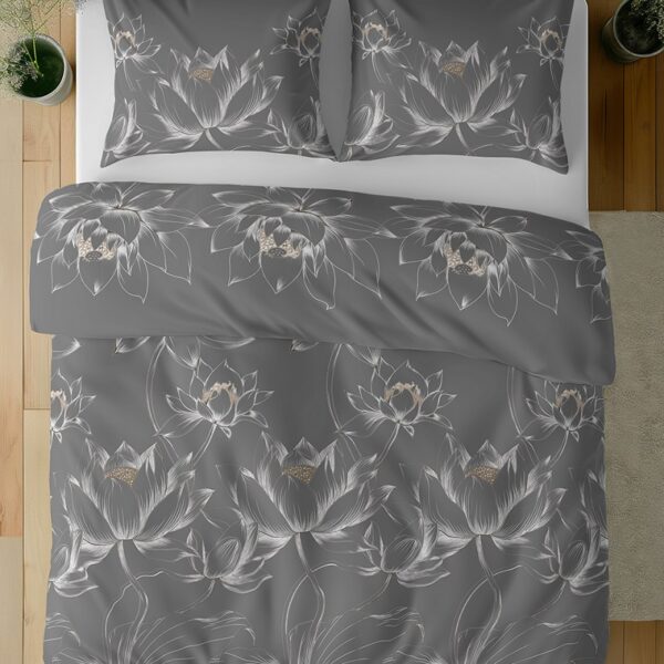 Top-down view of a bed with dark gray duvet and matching pillowcases adorned with white lotus flower designs.